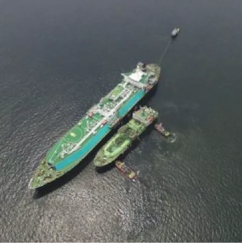 Aerial view of an LNG carrier with a small vessel alongside